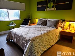 Sarasota apartment for rent - A bedroom with a large bed and a green wall.