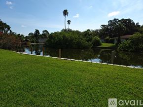 Sarasota apartment for rent - A grassy area with a body of water and trees in the background.