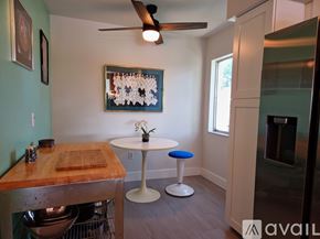Sarasota apartment for rent - A kitchen with a table and a ceiling fan.