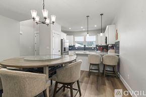 Lehi apartment for rent - A modern dining room with a round table and chairs.