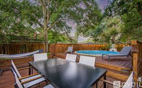 Houston house for rent - A backyard with a table and chairs and a pool.