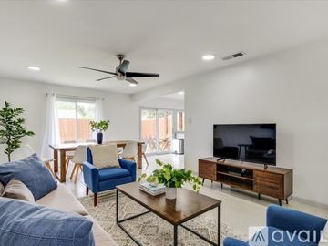 Irving house for rent - A living room with a blue chair and a television.