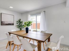 Irving house for rent - A dining room with a wooden table and white chairs.
