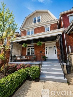 Pittsburgh house for rent - A house with a red brick exterior and a white door.