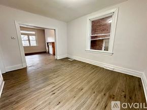Pittsburgh house for rent - A room with wooden flooring and a window with blinds.
