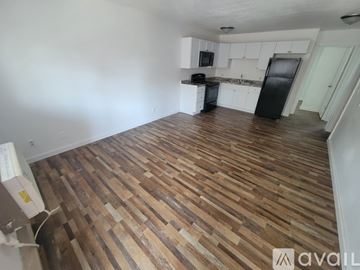 La Crosse apartment for rent - A kitchen with white cabinets and a black stove top oven.