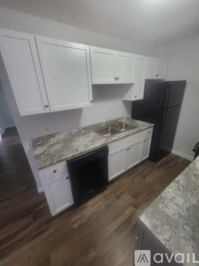 La Crosse apartment for rent - A room with wooden flooring and a kitchenette.