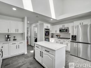 Allen house for rent - A modern kitchen with white cabinets and appliances.