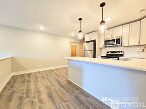 Chicago apartment for rent - A white bathroom with a marble wall and a toilet.