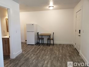 Green Forest apartment for rent - A kitchen area with a table and chairs and a refrigerator.