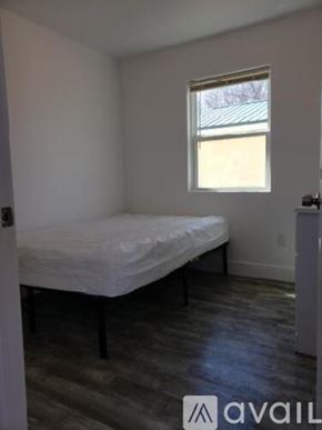 Green Forest apartment for rent - A bedroom with a bed and a window.