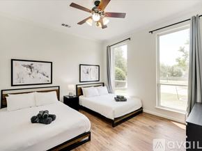 Rockwall house for rent - A bedroom with a white bed and a bunk bed with a white mattress.
