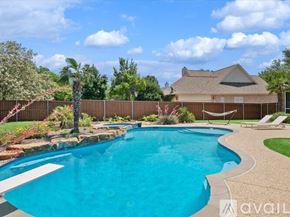 Rockwall house for rent - A swimming pool in a backyard with a house in the background.