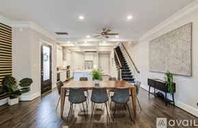 Houston house for rent - A bedroom with a bed, two lamps, and a painting on the wall.