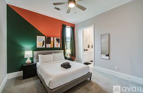 Houston house for rent - A backyard with a hot tub, patio furniture, and a wooden fence.