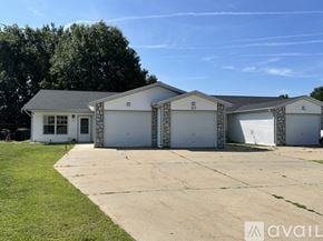 Nekoosa apartment for rent - A large white house with a garage is available for rent.