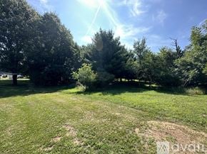 Nekoosa apartment for rent - A sunny day in a grassy field with trees.