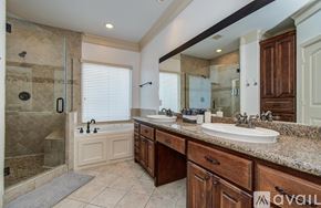 Houston house for rent - A pool with a hot tub and a barbecue grill.