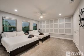 Lewisville house for rent - A bedroom with two beds and a ceiling fan.