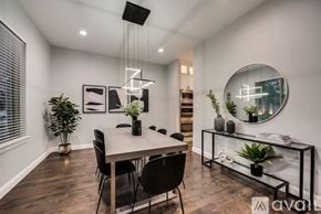 Lewisville house for rent - A modern dining room with a large table and chairs.