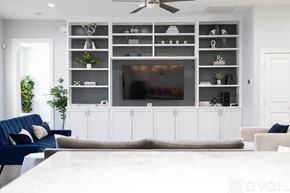 Lewisville house for rent - A modern kitchen with a stove top oven and white cabinets.