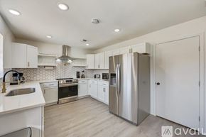 Fort Worth house for rent - A kitchen with white cabinets and stainless steel appliances.