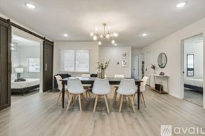 Fort Worth house for rent - A modern dining room with a black table and white chairs.