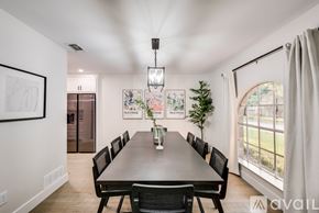 Plano house for rent - A dining room with a long table and chairs.