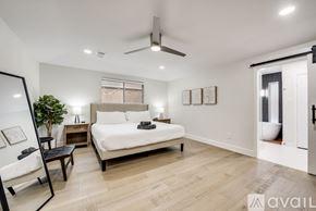 Plano house for rent - A bedroom with a large bed and a ceiling fan.