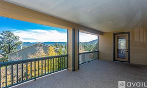 Prescott house for rent - A balcony with a view of the mountains and trees.