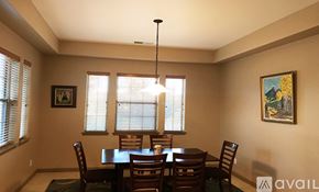 Prescott house for rent - A dining room with a table set for two and a chandelier hanging from the ceiling.