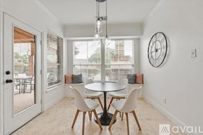Rowlett house for rent - A dining room with a table and chairs and a clock on the wall.