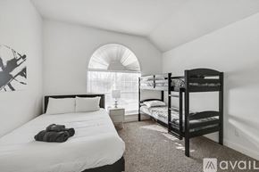 Flower Mound house for rent - A bedroom with a large bed and a bunk bed.