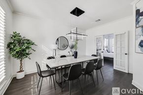 Flower Mound house for rent - A dining room with a white table and black chairs.