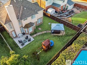 Flower Mound house for rent - A backyard with a patio, a hot tub, and a pool.