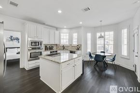 Flower Mound house for rent - A modern kitchen with a dining table and chairs.