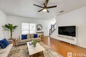 Rowlett house for rent - A kitchen with a stainless steel refrigerator and a blue dishwasher.