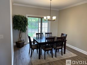New Hartford townhouse for rent - A dining room with a table and chairs and a potted plant.