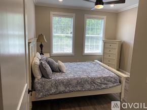 New Hartford townhouse for rent - A bedroom with a bed, dresser, and window.