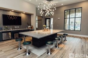 Mckinney apartment for rent - A modern kitchen with a central island and a bar area.