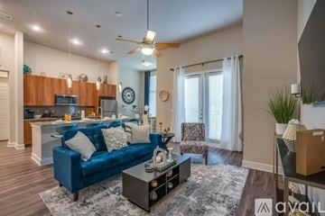 Mckinney apartment for rent - A living room with a blue couch and a coffee table.