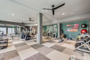 Dallas apartment for rent - A gym with a variety of equipment including treadmills, stationary bikes, and weight machines.