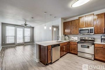 Dallas apartment for rent - A kitchen with wooden cabinets and stainless steel appliances is available for rent.