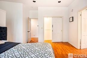 Weston apartment for rent - A bedroom with a bed and a wooden floor.