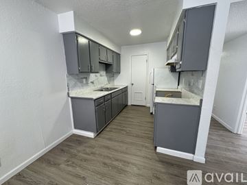 Fort Stockton apartment for rent - A kitchen with grey cabinets and a white countertop is available for rent.