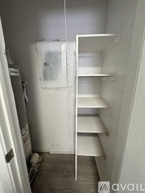 Fort Stockton apartment for rent - A white shelving unit in a room with a door on the left.