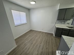 Fort Stockton apartment for rent - A room with wooden flooring and a window with blinds.