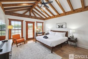 Mckinney house for rent - A bedroom with a large bed and a ceiling fan.