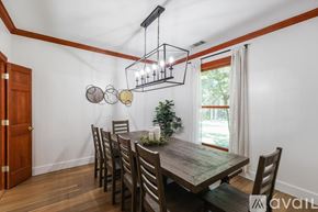 Mckinney house for rent - A dining room with a wooden table and chairs.