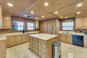 Celina house for rent - A kitchen with wooden cabinets and a large island.
